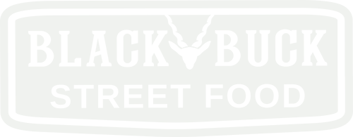 Logo featuring bold, uppercase letters on a white background within an oval border that points down, with a stylised image of a deer's head and antlers centred above the text, which reads 'STREET FOOD'.