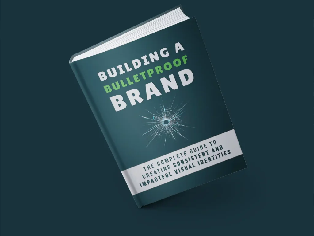 E-book mockup titled 'Building a Bulletproof Brand' featuring a cover with bold typography and a bullet hole graphic, with a subtitle reading 'The Complete Guide to Creating Consistent and Impactful Visual Identities,' set against a dark blue background.