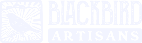 Logo for Blackbird Artisans, featuring a hand-drawn blackbird within a rectangular frame with sunburst rays, accompanied by bold, rustic text 'BLACKBIRD' and 'ARTISANS' below.